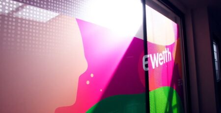 Perforated window vinyl creating one-way vision effect.