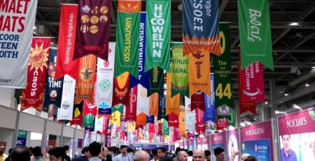 Colorful event banners displayed at a lively venue.