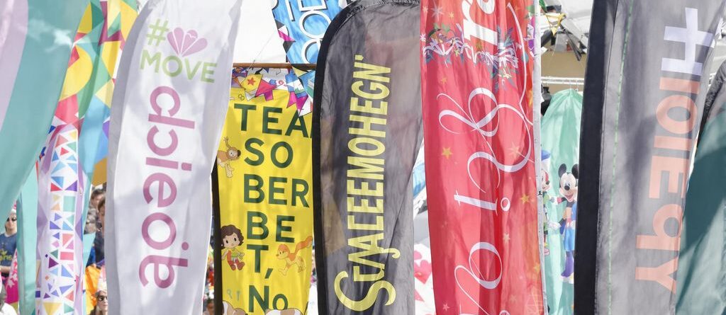Colorful banners fluttering outdoors at an event.