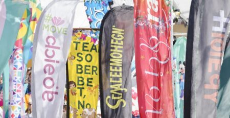 Colorful banners fluttering outdoors at an event.