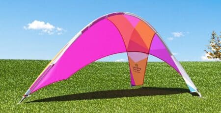 Teardrop banner, outdoor event, blue sky, green grass.