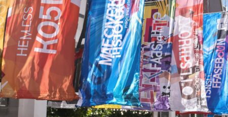 Printed banners hanging outdoors, bright colors.