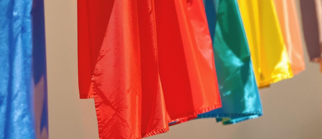 Colorful banners fluttering in a sunlit breeze.