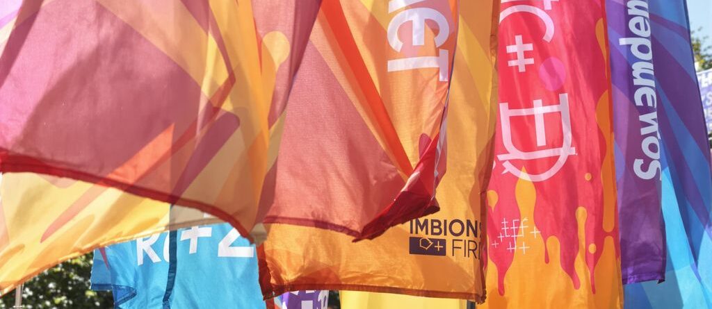 Vibrant custom banners outdoors, catching the light.