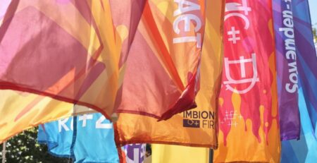 Vibrant custom banners outdoors, catching the light.
