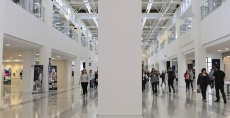 Large banner stand in a spacious exhibition hall.
