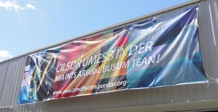 Large, vibrant custom business banner, high-quality print, outdoors.