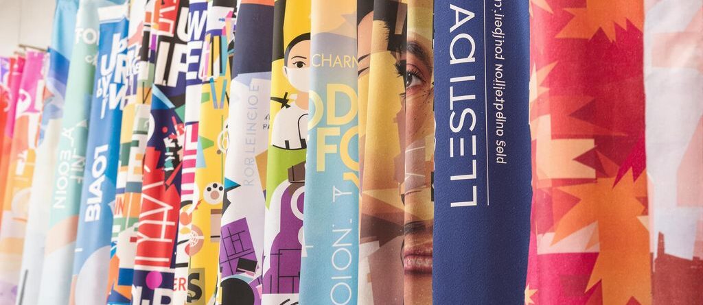 Colorful banners, various sizes, displayed indoors.