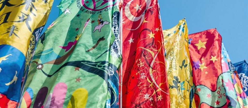 Custom flag waving against blue sky.