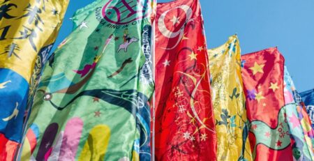 Custom flag waving against blue sky.