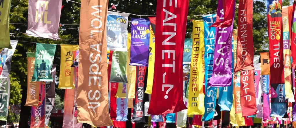 Colorful banners fluttering outdoors at an event.