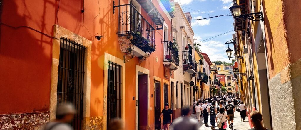 Vibrant Tlaxcala street scene with colorful banners.