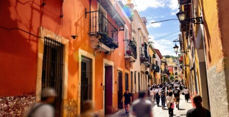 Vibrant Tlaxcala street scene with colorful banners.