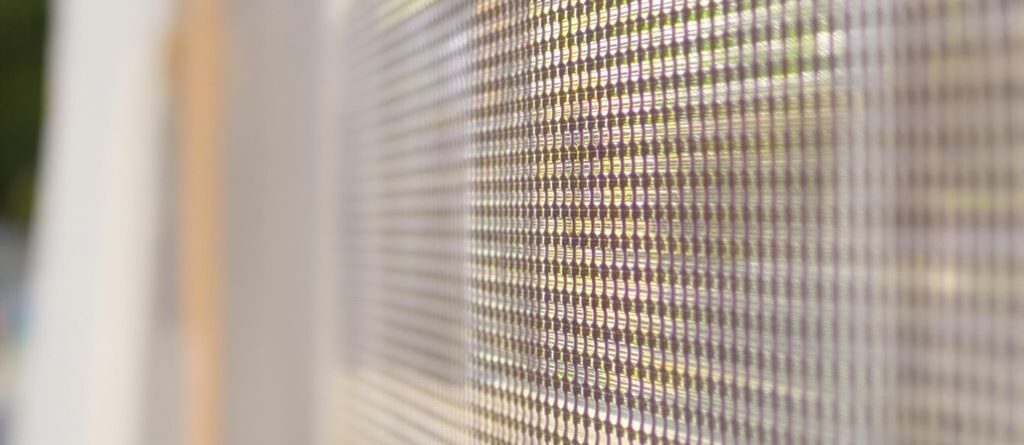 Mesh banner fluttering outdoors in sunlight.