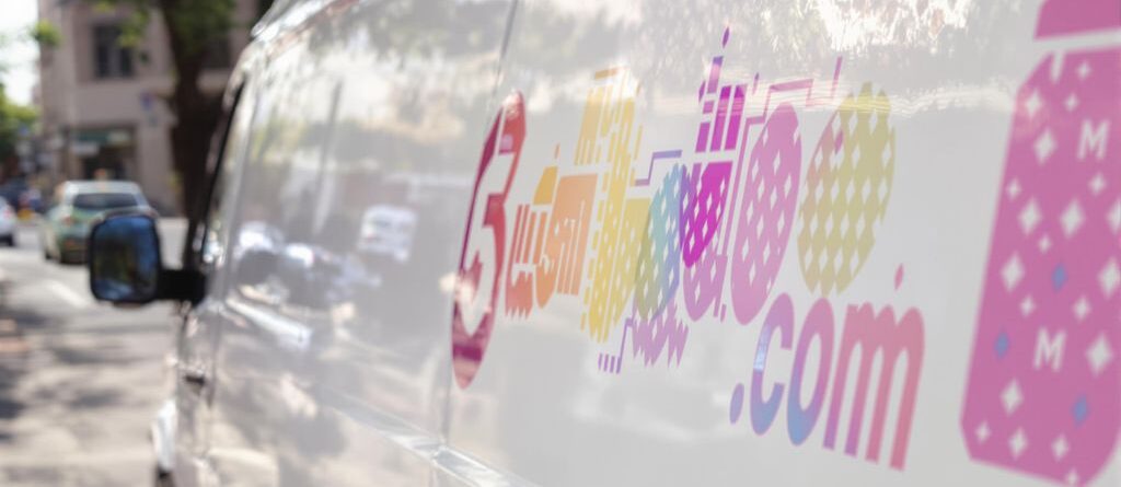 Perforated decals on vehicles and storefronts.