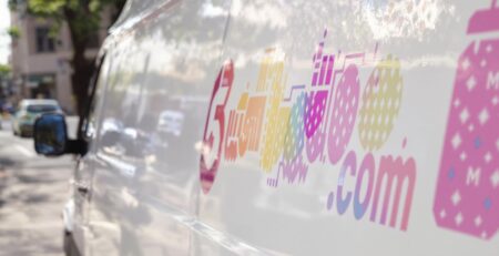Perforated decals on vehicles and storefronts.