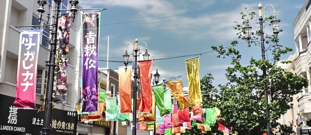 Community banners hang from lampposts along a city street.