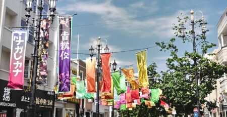Community banners hang from lampposts along a city street.