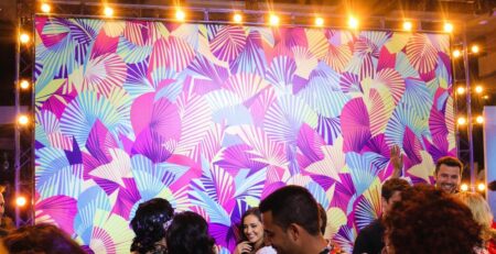 Elegant step and repeat backdrop at a lively event.