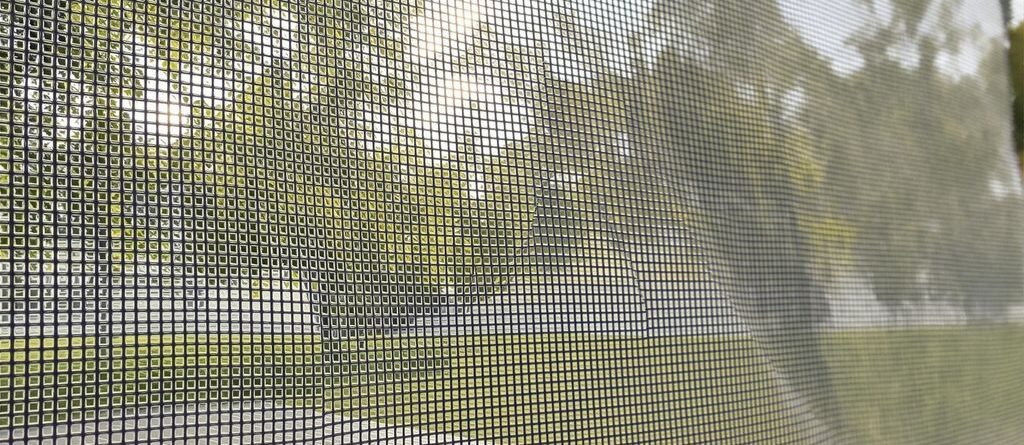Mesh banners hanging outdoors, bright and vibrant.