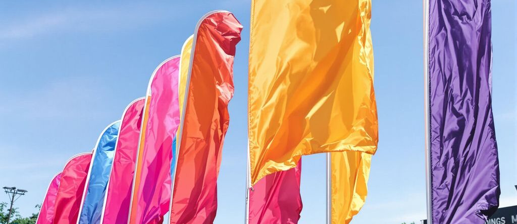 Colorful feather flags outdoors, waving in a sunny breeze.