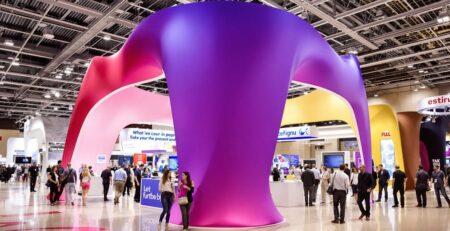 Brightly lit fabric booth at trade show.