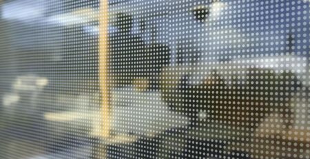 Perforated vinyl on a business window, close-up.