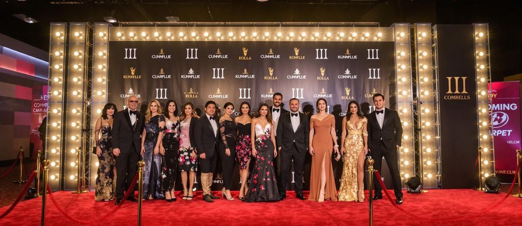 Backdrop with bright lights and a red carpet.