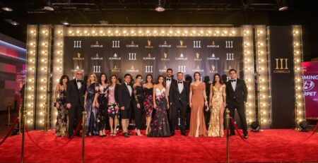 Backdrop with bright lights and a red carpet.