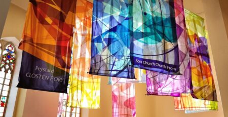 Colorful church banners, light streaming in.