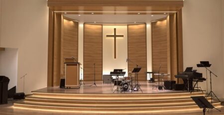 Modern church stage with warm lighting.